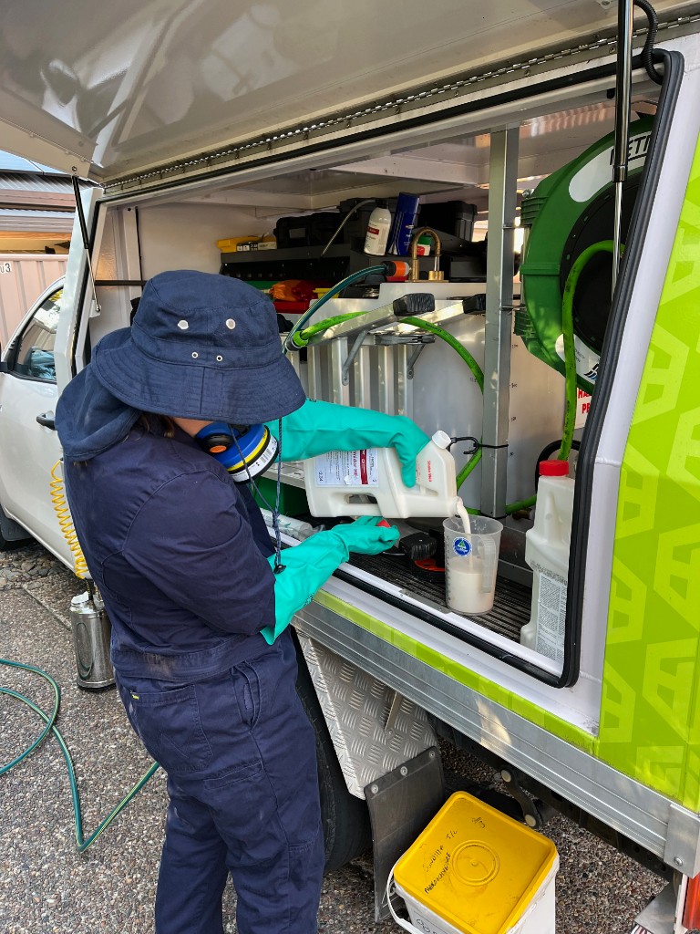 Pest technician preparing pest management treatment