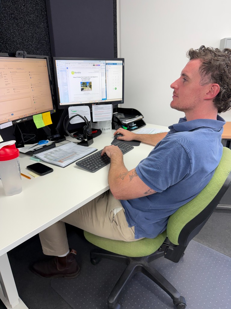 Sales and management staff member reviewing general pest course materials at a desk