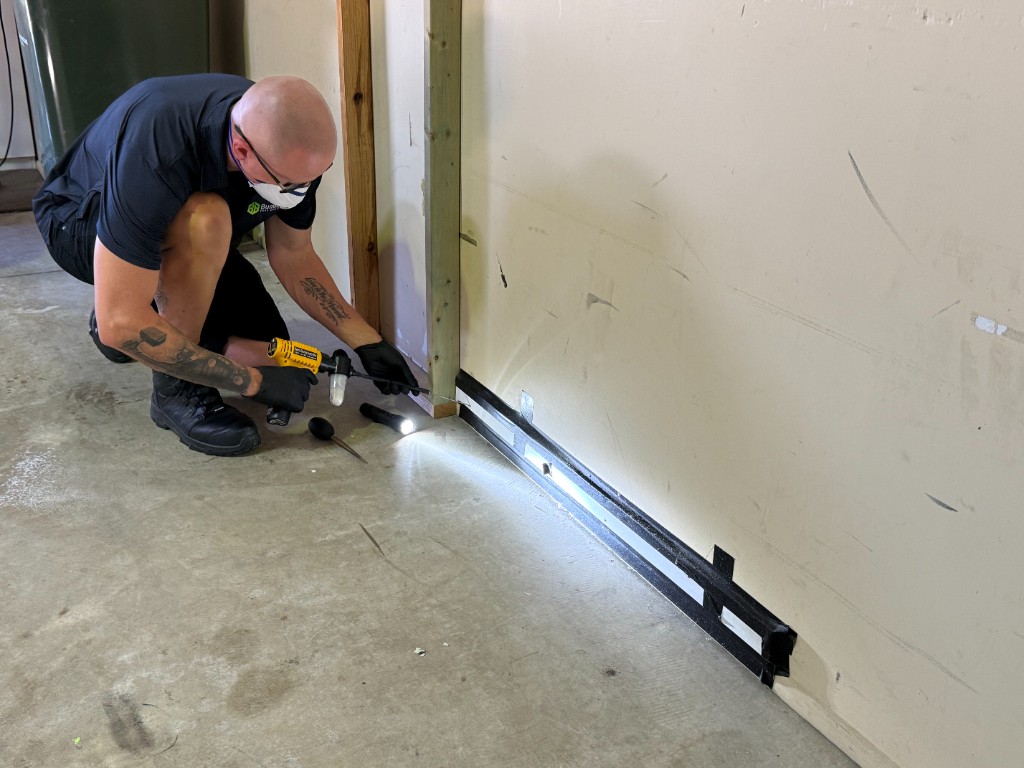 Pest control technician applying precise indoor treatment during practical workplace training