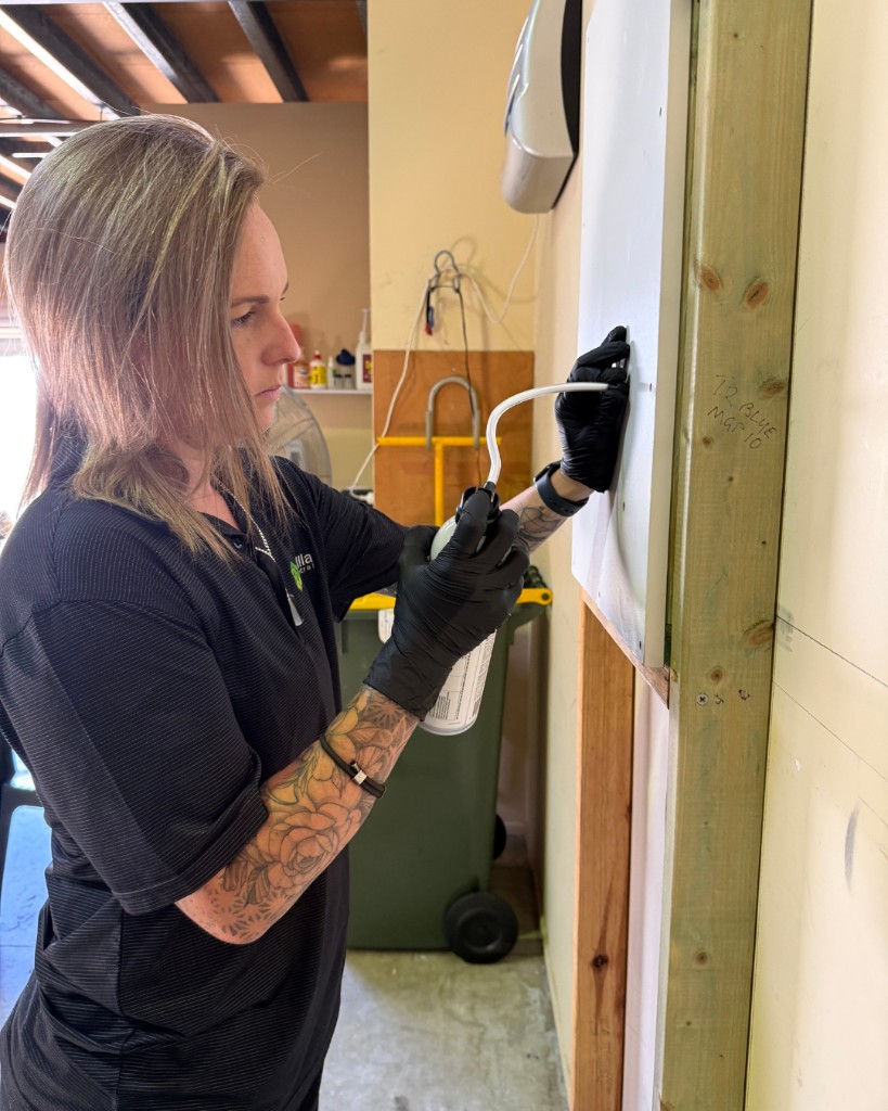 Technician applying precision treatment using an aerosol applicator in a hands-on training setting