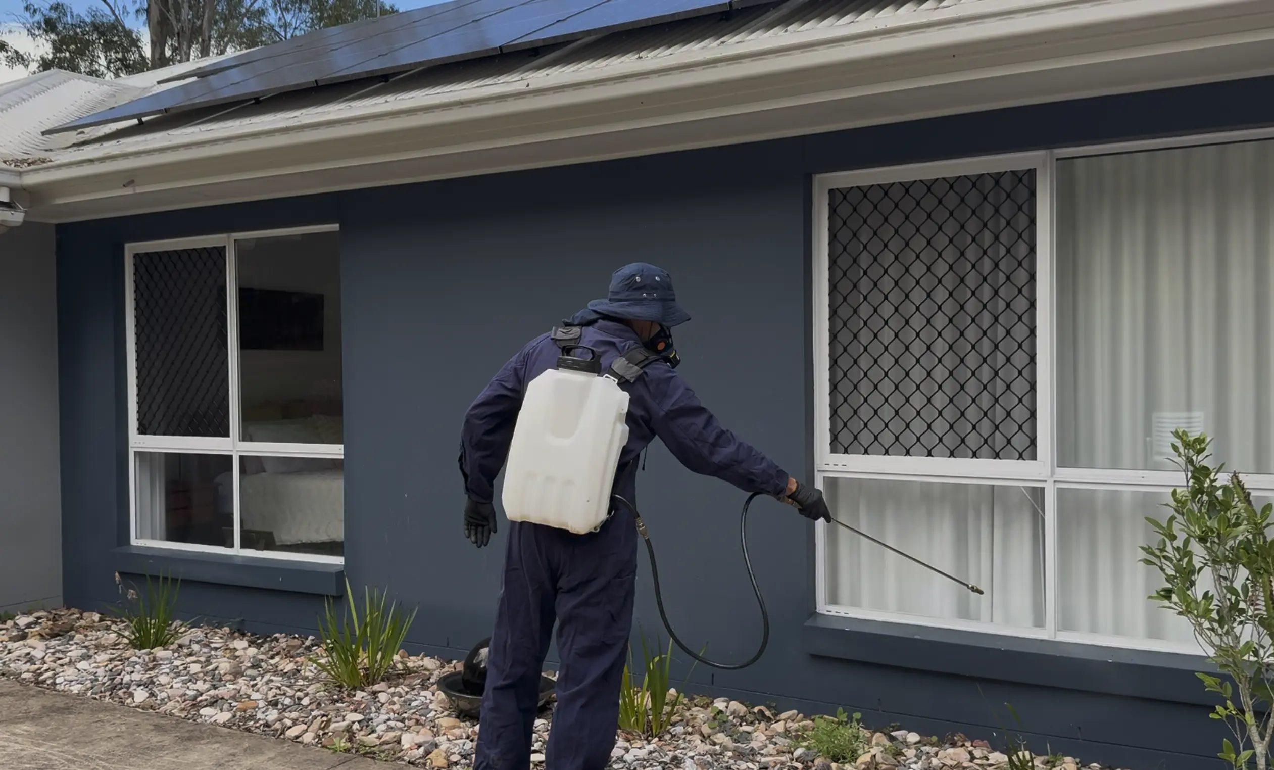Pest control technician spraying for pests