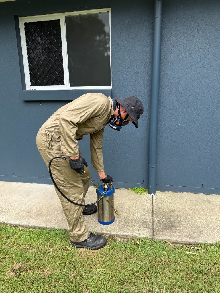 Technician applying treatment during hands-on pest control training